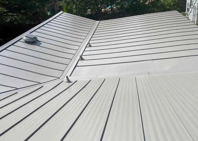 Solar attic fan installed on a metal roof for Roof Ventilation in Texas